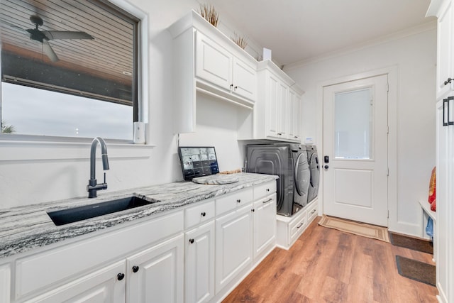 10794 County Road 334, Tyler, TX 75708 - laundry area featuring ornamental molding, a ceiling fan, a sink, light wood-type flooring, and washer and clothes dryer