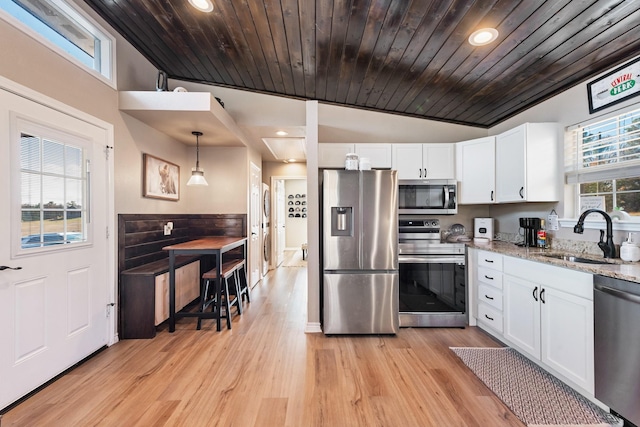 kitchen featuring appliances with stainless steel finishes, wood ceiling, sink, white cabinetry, and hanging light fixtures