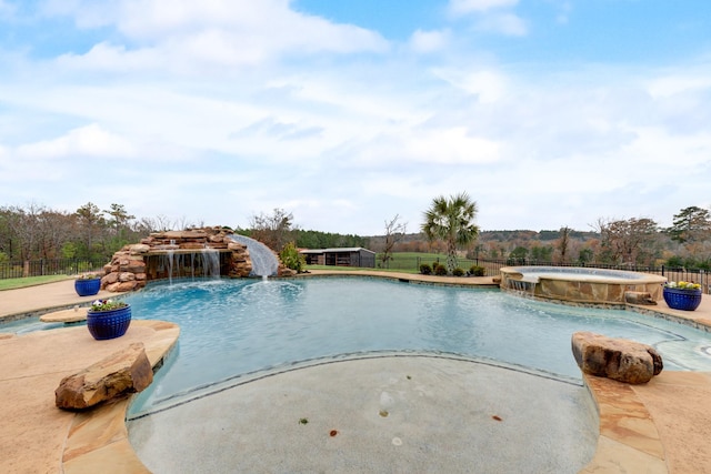 view of swimming pool with an in ground hot tub and pool water feature