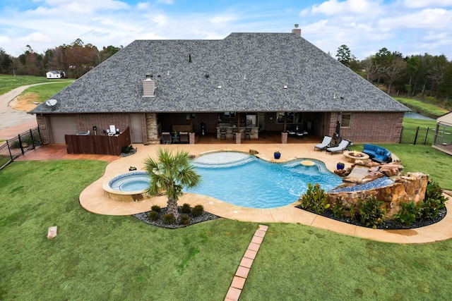 view of swimming pool featuring exterior bar, an in ground hot tub, a patio area, and a lawn