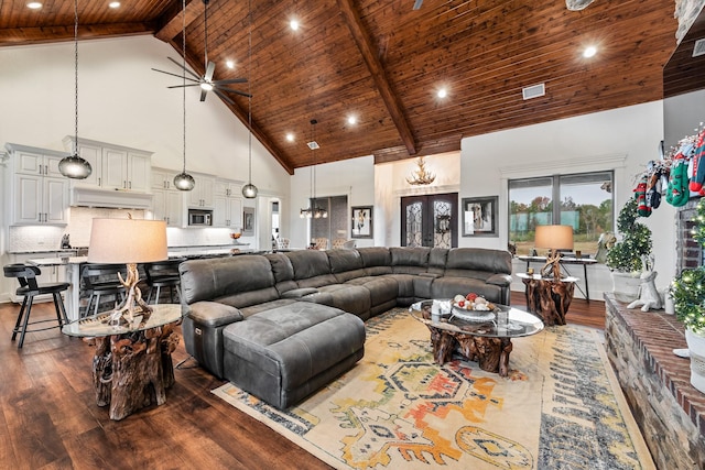 living room with hardwood / wood-style floors, high vaulted ceiling, ceiling fan, beamed ceiling, and wood ceiling