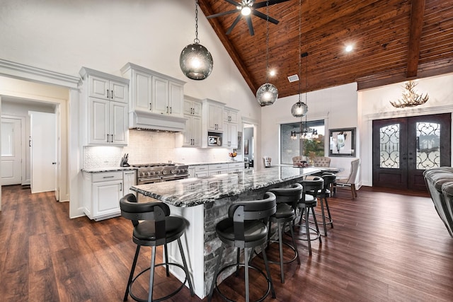 10794 County Road 334, Tyler, TX 75708 - kitchen with wooden ceiling, range hood, backsplash, stone counters, and range with two ovens