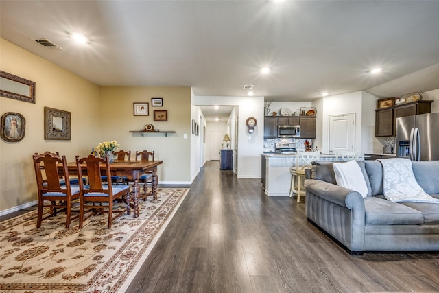 living room with dark hardwood / wood-style flooring