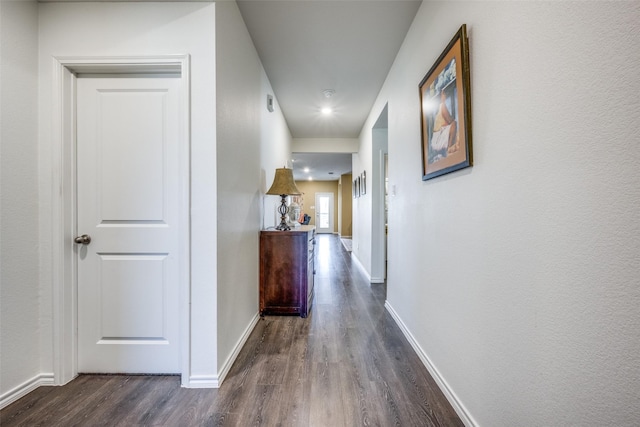 corridor with dark hardwood / wood-style floors