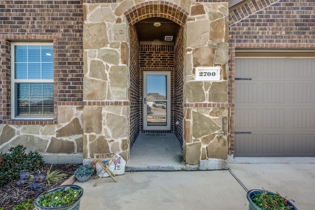 view of exterior entry featuring a garage