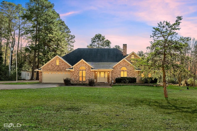 view of front of home with a lawn and a garage