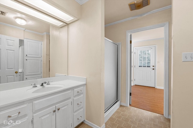 bathroom featuring vanity, an enclosed shower, and crown molding