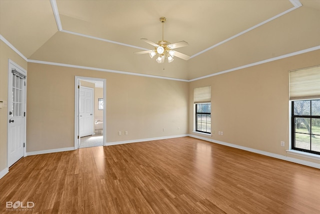 empty room featuring wood-type flooring, vaulted ceiling, ceiling fan, and ornamental molding