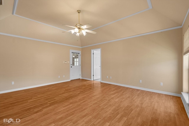 empty room featuring light wood-type flooring, vaulted ceiling, ceiling fan, and ornamental molding