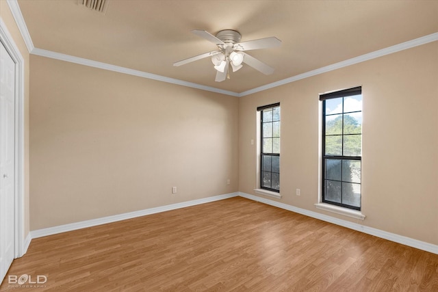 empty room featuring ceiling fan, light wood-type flooring, and ornamental molding