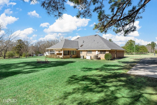 rear view of house featuring a lawn