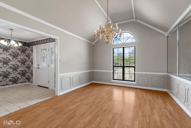 unfurnished dining area featuring a chandelier, ornamental molding, light hardwood / wood-style floors, and lofted ceiling