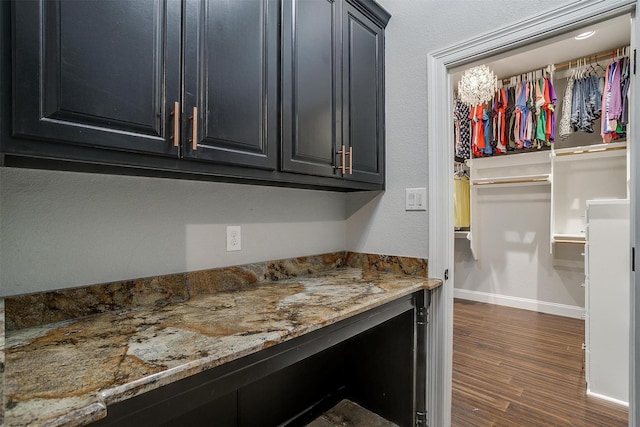 interior space featuring dark hardwood / wood-style flooring and light stone counters