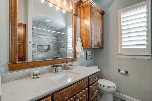 bathroom with vanity, toilet, and a wealth of natural light