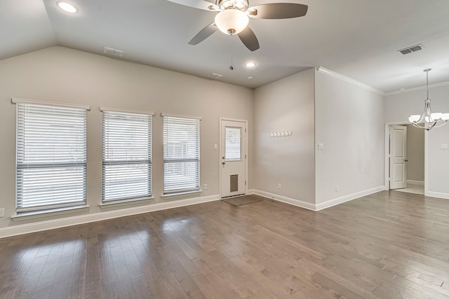 unfurnished room featuring hardwood / wood-style floors, ceiling fan with notable chandelier, vaulted ceiling, and crown molding