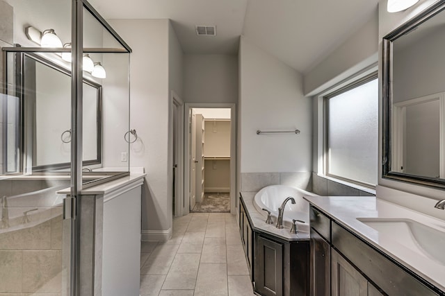 bathroom with tile patterned flooring, vanity, vaulted ceiling, and plus walk in shower