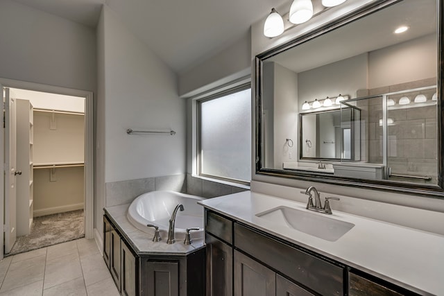 bathroom featuring vaulted ceiling, vanity, separate shower and tub, and tile patterned floors