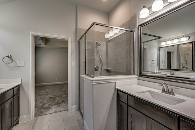 bathroom featuring tile patterned flooring, vanity, and a shower with shower door