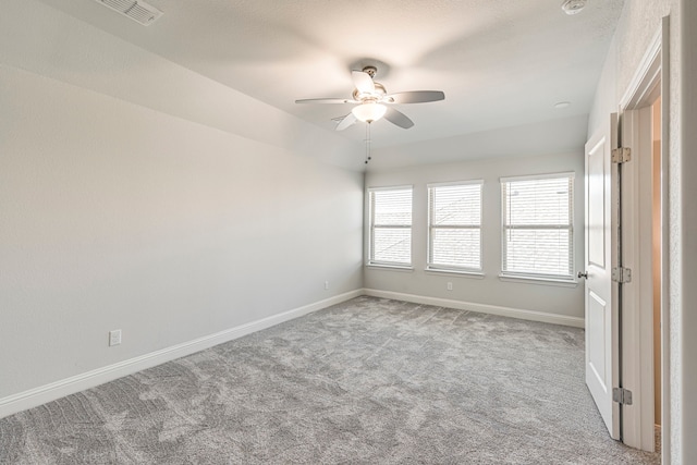 carpeted empty room with ceiling fan