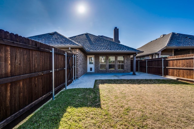 rear view of property featuring a patio area and a yard