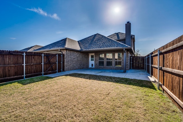 back of property featuring a yard and a patio area