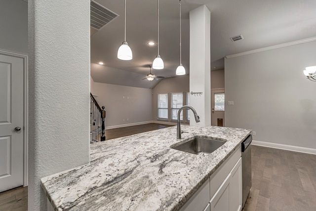 kitchen featuring white cabinetry, dishwasher, sink, hanging light fixtures, and light stone countertops