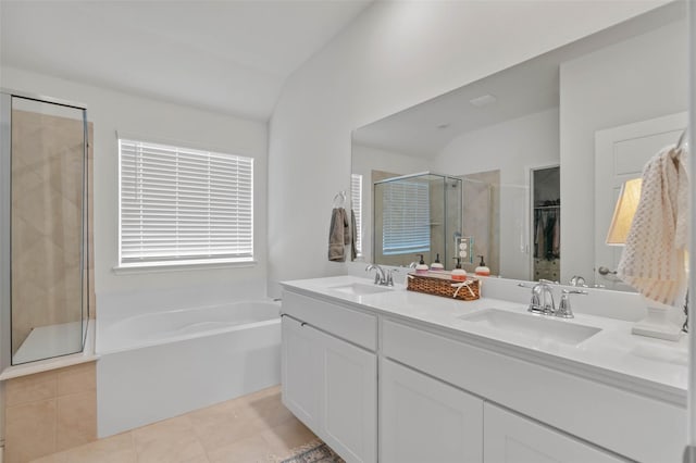 bathroom featuring plus walk in shower, vanity, tile patterned floors, and vaulted ceiling