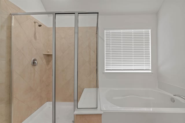 bathroom featuring separate shower and tub