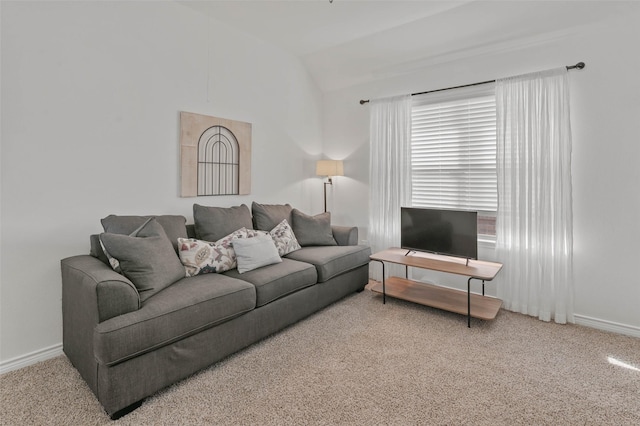 carpeted living room with lofted ceiling