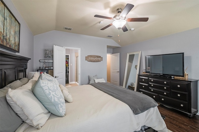 bedroom featuring ceiling fan, dark wood-type flooring, and lofted ceiling