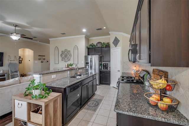 kitchen featuring gas stove, a kitchen island with sink, crown molding, stone counters, and dishwasher