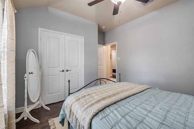 bedroom with ceiling fan, dark hardwood / wood-style floors, lofted ceiling, and a closet