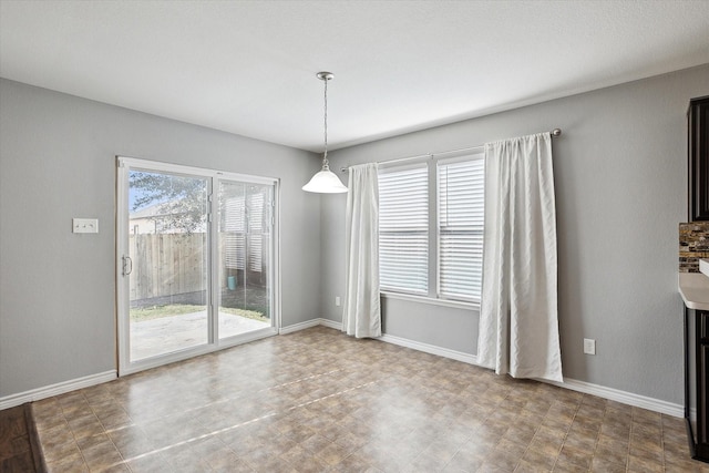 unfurnished dining area featuring a wealth of natural light