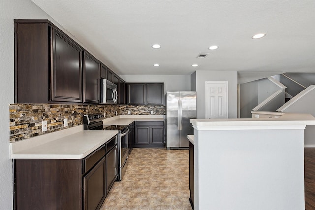 kitchen with tasteful backsplash, dark brown cabinetry, and appliances with stainless steel finishes