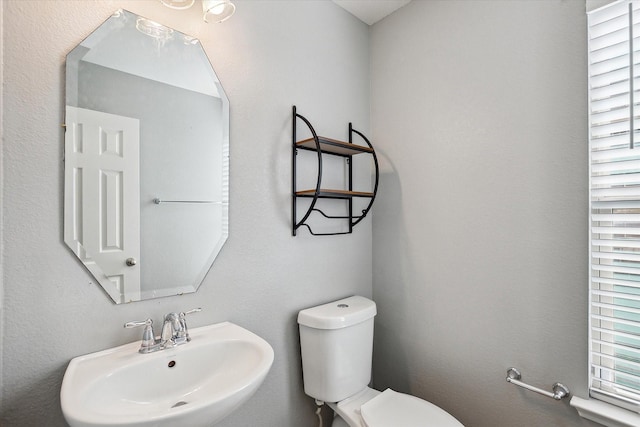 bathroom featuring toilet and sink