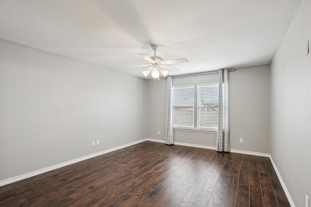 spare room featuring ceiling fan and dark hardwood / wood-style floors