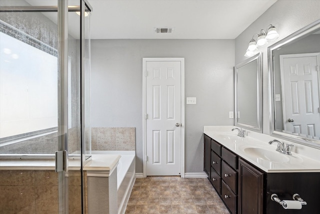 bathroom featuring vanity and shower with separate bathtub