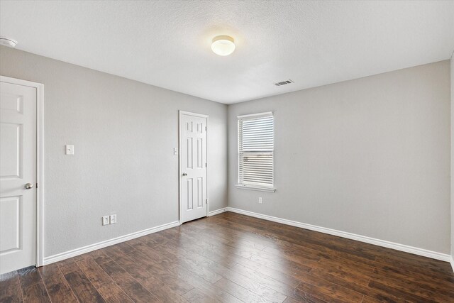 empty room with dark hardwood / wood-style floors