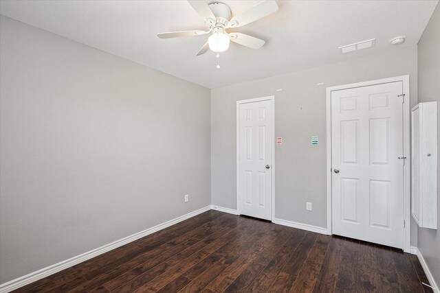 unfurnished bedroom featuring dark hardwood / wood-style flooring and ceiling fan