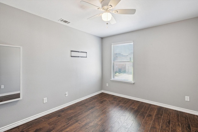 empty room with ceiling fan and dark wood-type flooring