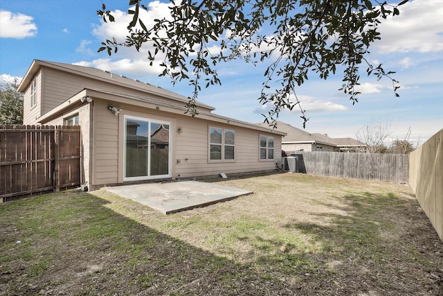 rear view of property with a lawn and a patio area