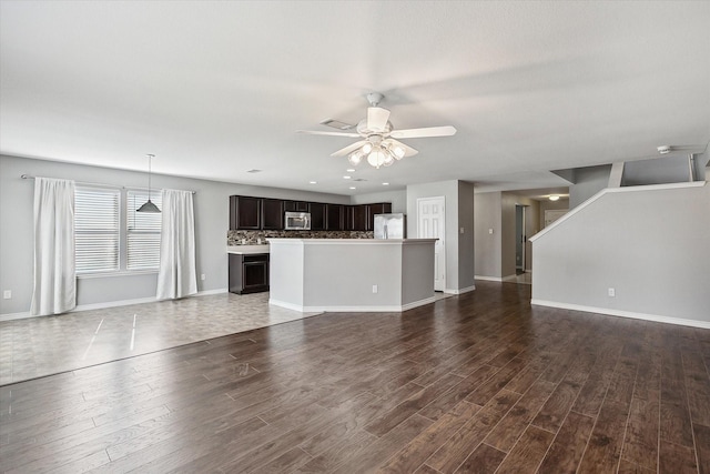 unfurnished living room with ceiling fan and hardwood / wood-style floors