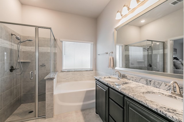 bathroom with tile patterned flooring, vanity, and separate shower and tub