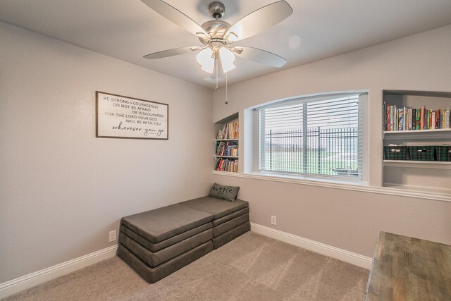 living area with ceiling fan and carpet floors