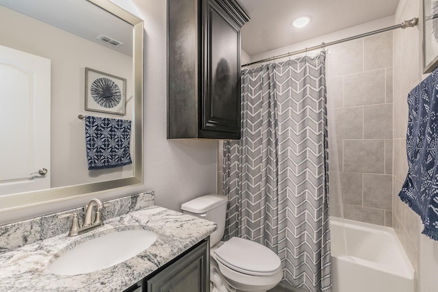 full bathroom featuring shower / tub combo, vanity, and toilet