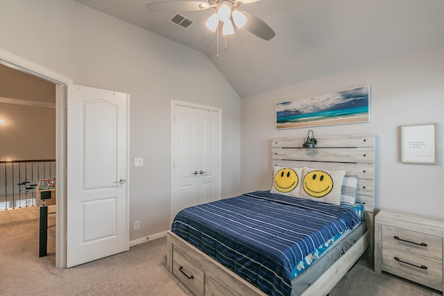 carpeted bedroom with ceiling fan, a closet, and lofted ceiling