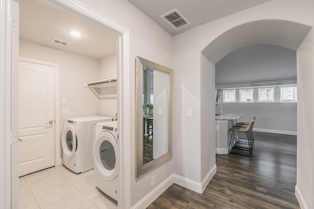 washroom featuring washer and clothes dryer and hardwood / wood-style floors