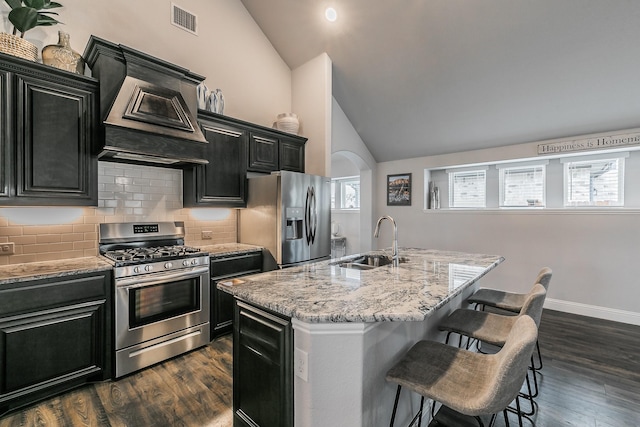 kitchen with a center island with sink, sink, and stainless steel appliances