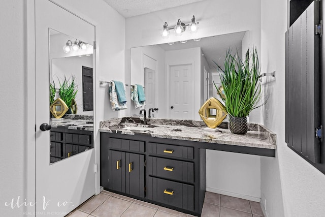 bathroom with vanity, tile patterned flooring, and a textured ceiling