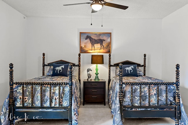 carpeted bedroom with ceiling fan and a textured ceiling